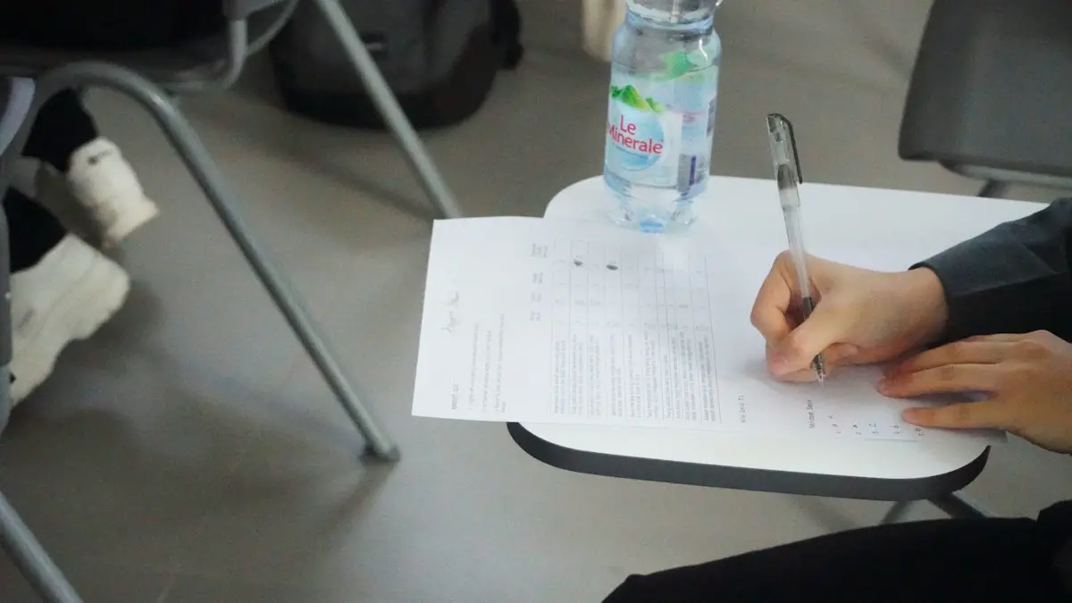 A person writing on a piece of paper.