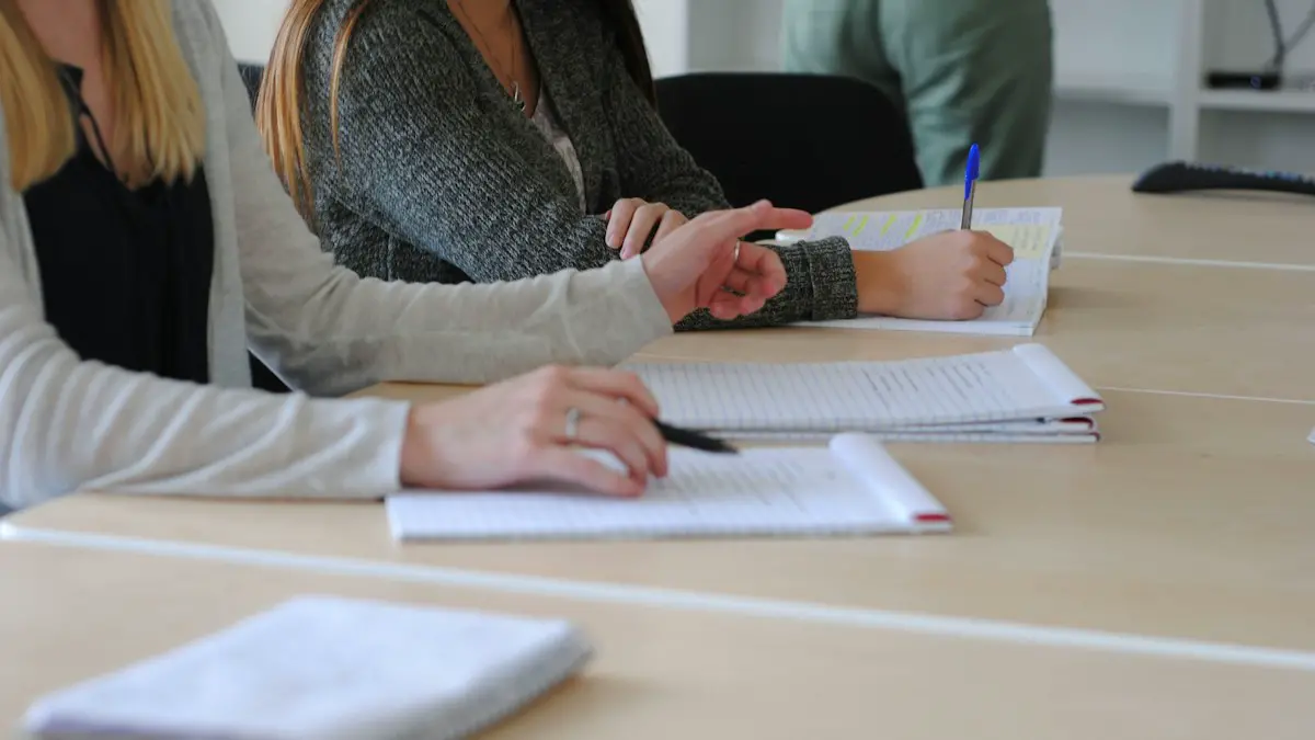 A woman writing on a piece of paper.
