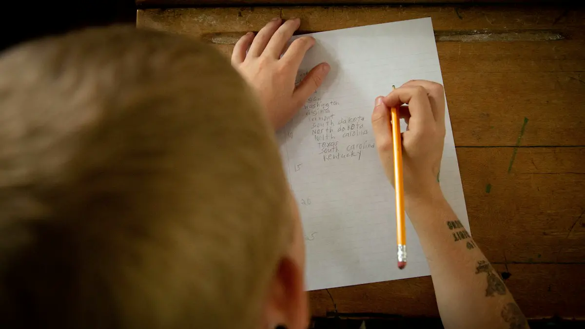 Person writing on white paper.
