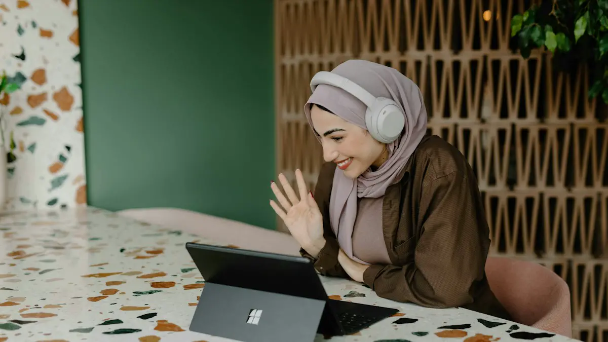A person sitting on a table with a laptop.