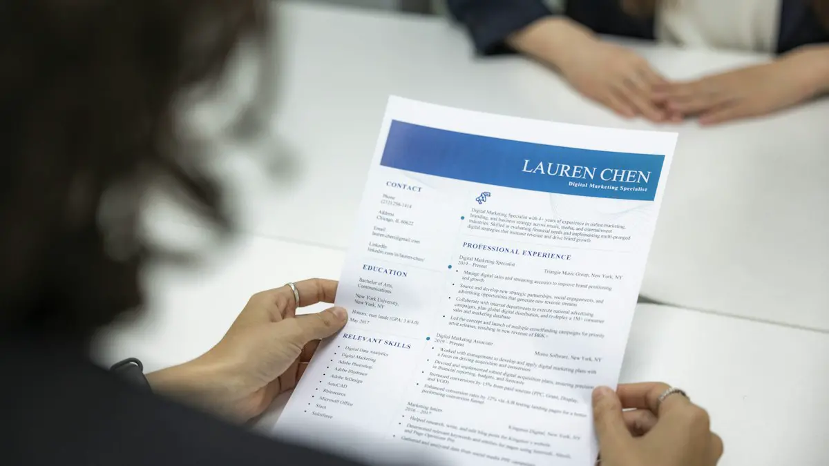 A woman is reading a resume at a table.