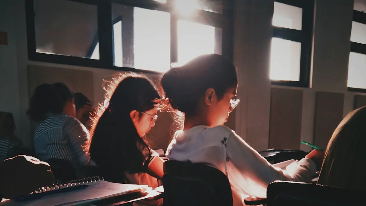 Students in a sunlit classroom reading from open textbooks at their desks.