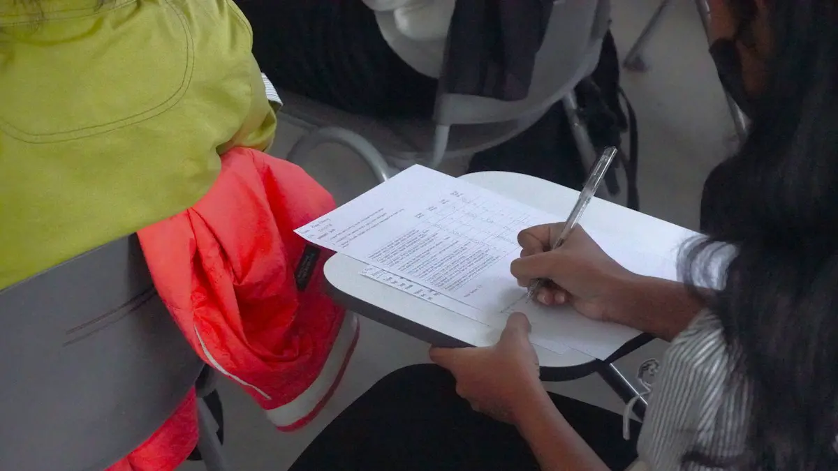 A person writing on a piece of paper.