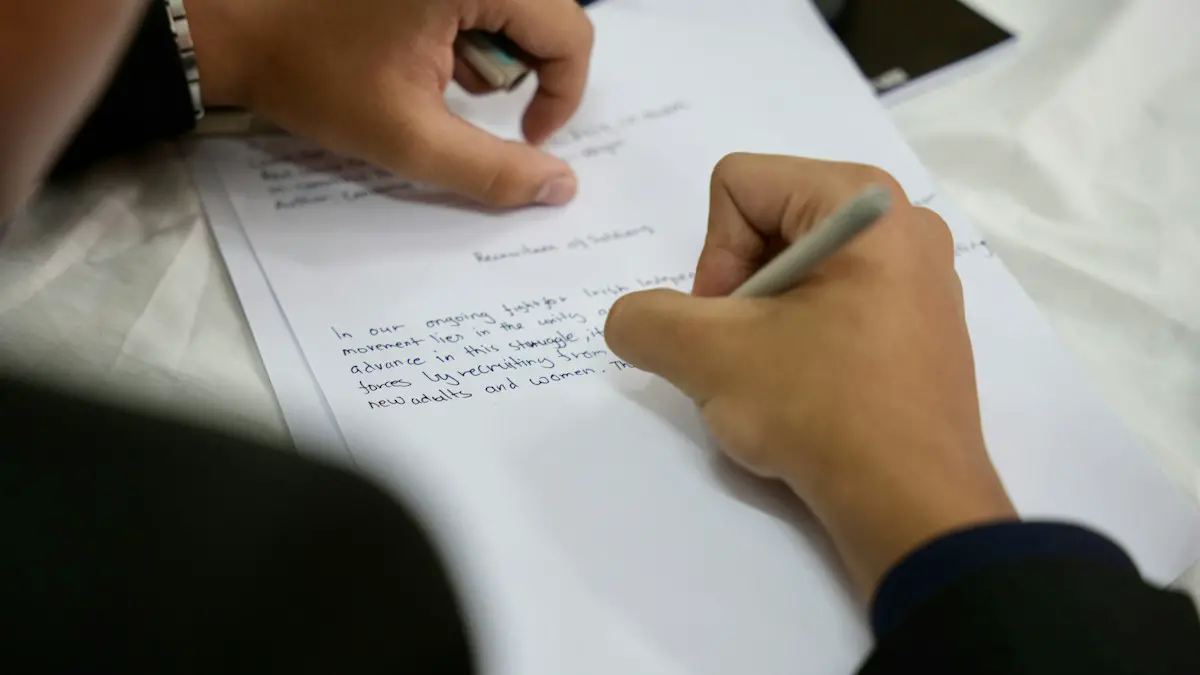 A person writing on a piece of paper.