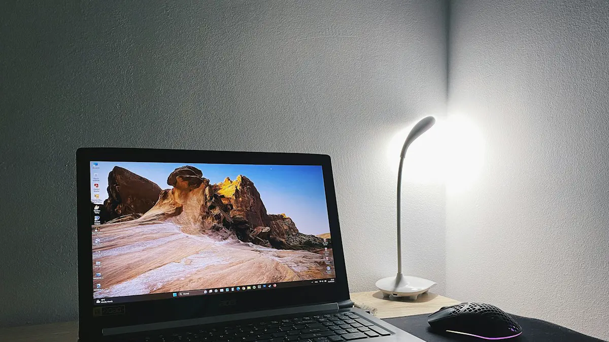 A laptop computer sitting on top of a wooden desk.