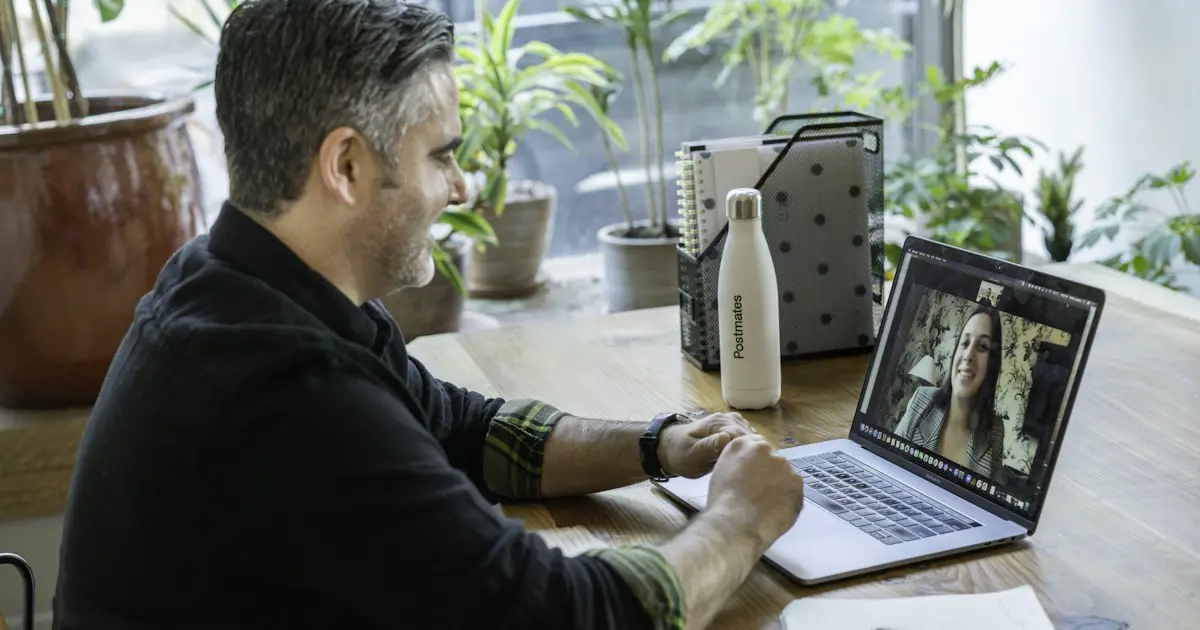 A candidate on a video call, taking notes.