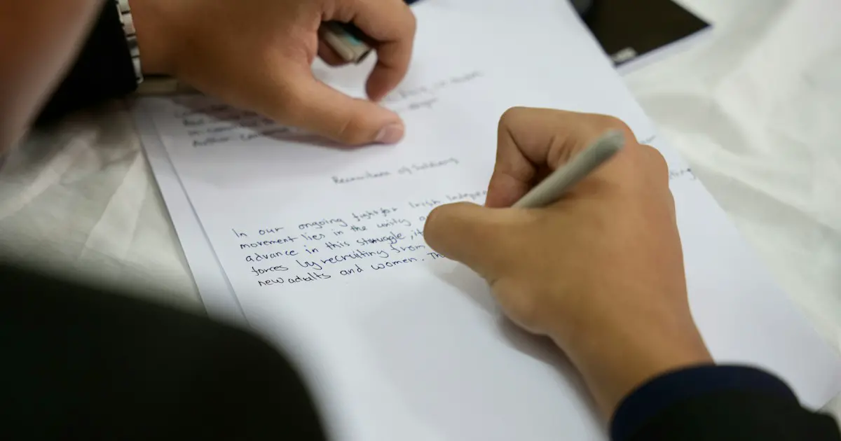 Writing an essay by hand against the clock.