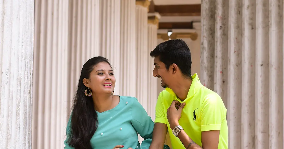 Two friends talking on college steps.