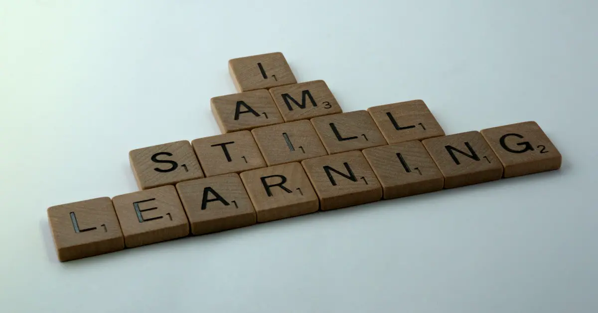 Letter tiles spelling "I am still learning".