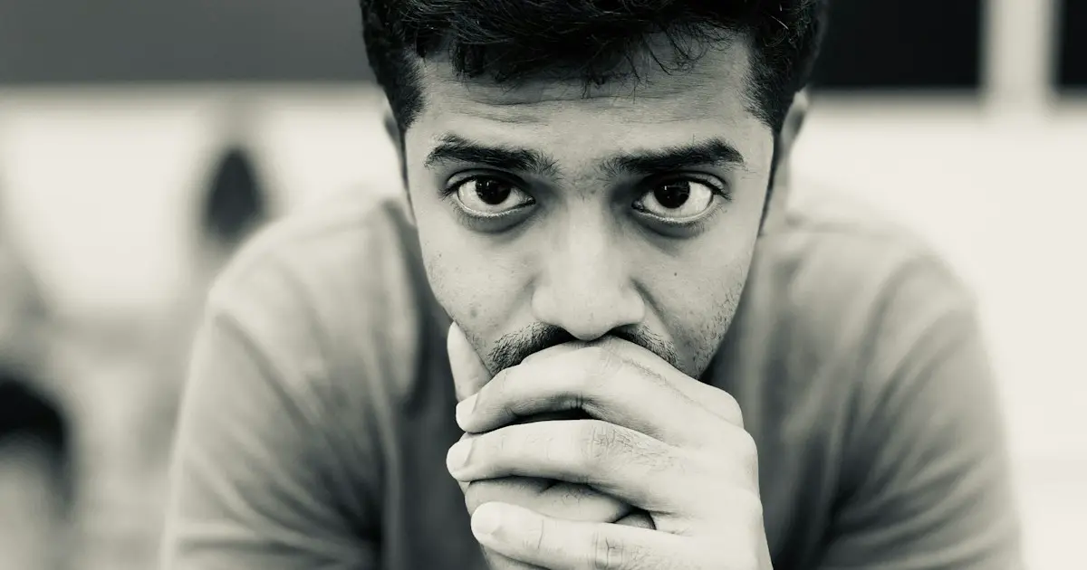 A young man deep in thought before an interview.