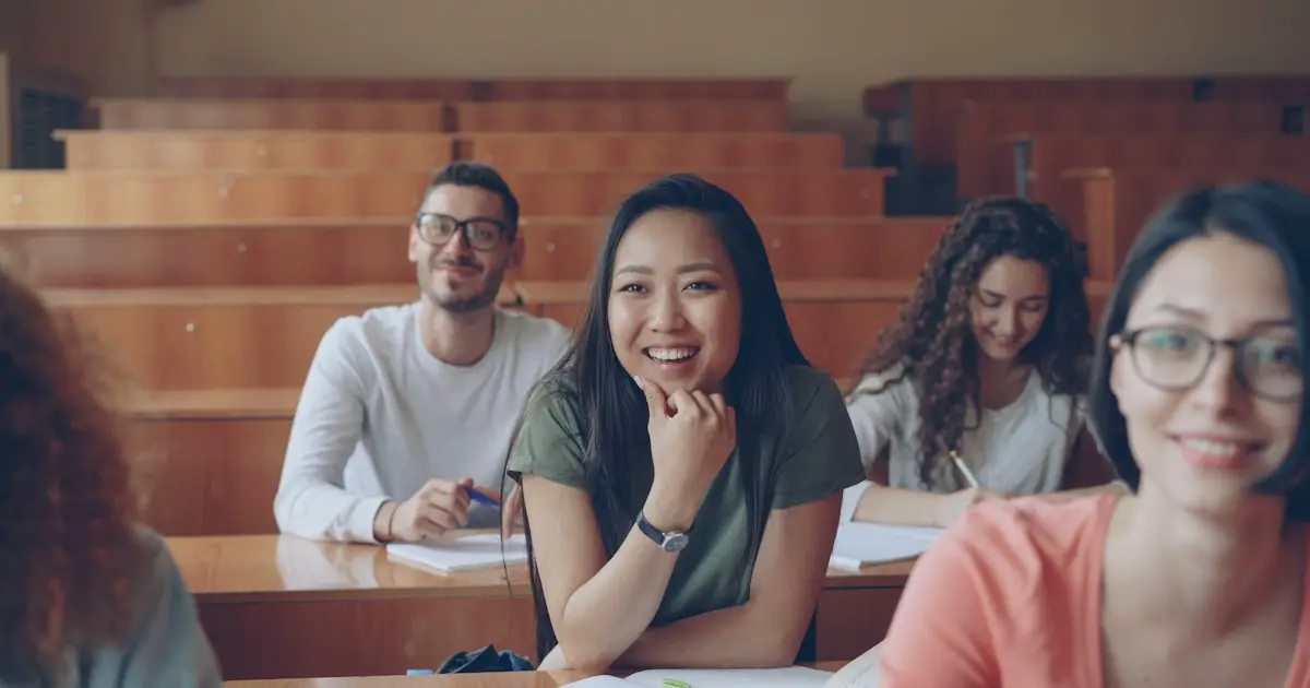 Students smiling in a lecture hall.