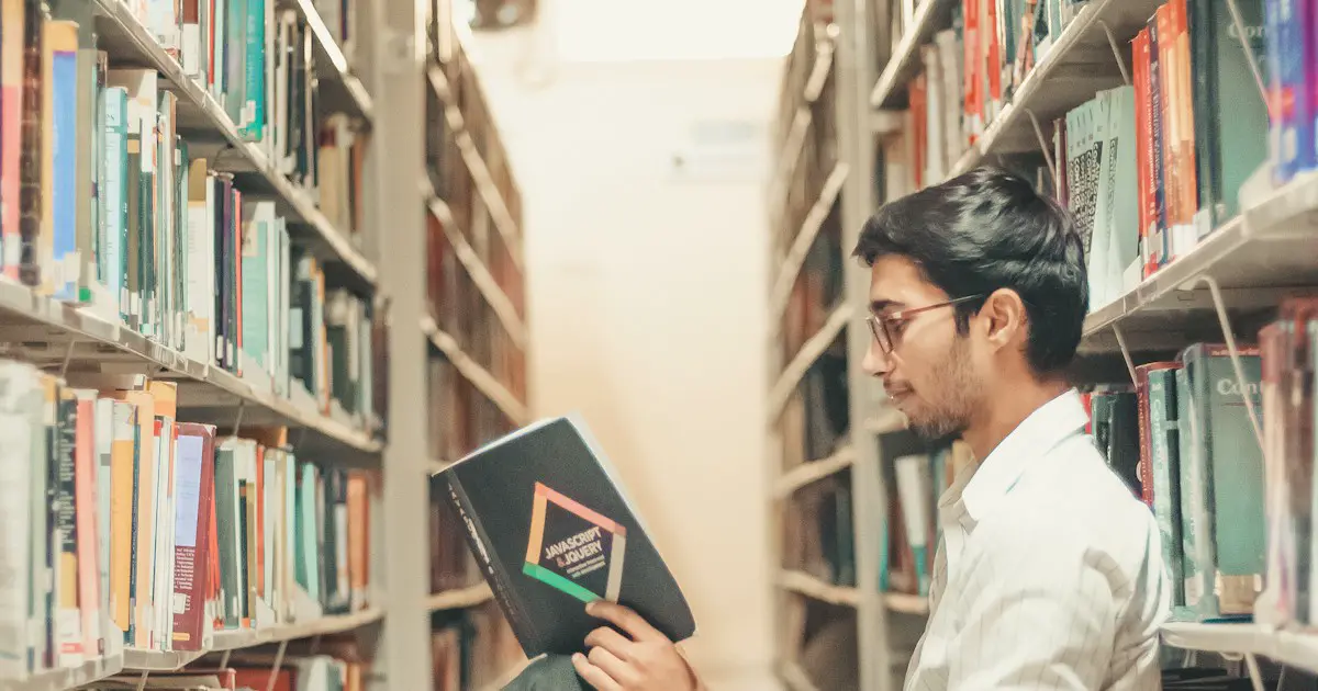 A student choosing a book in the library.