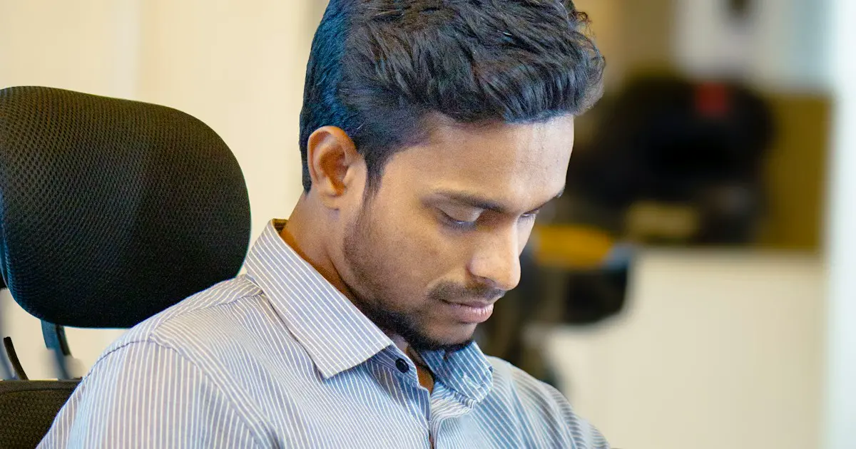 A young professional in a formal shirt at work.