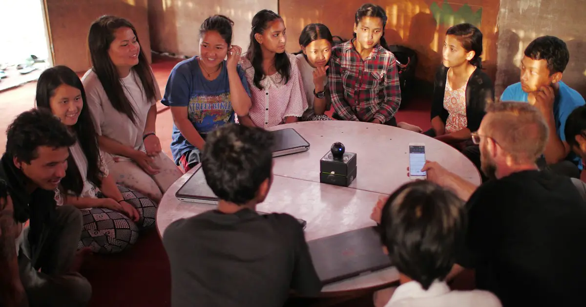 A group of students sitting in a circle, discussing a topic.