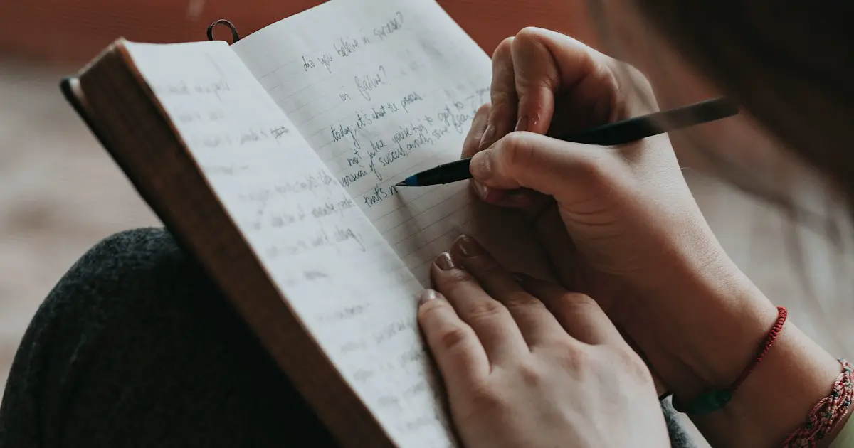 Writing a short diary entry in a notebook.