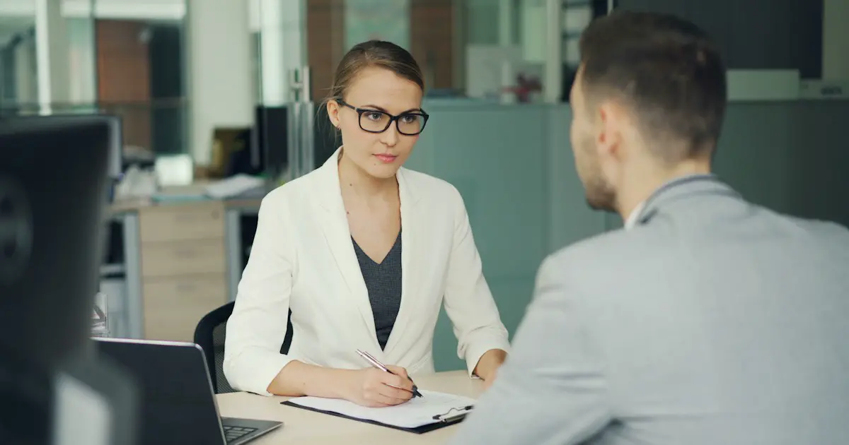 A candidate answering questions in a formal interview.
