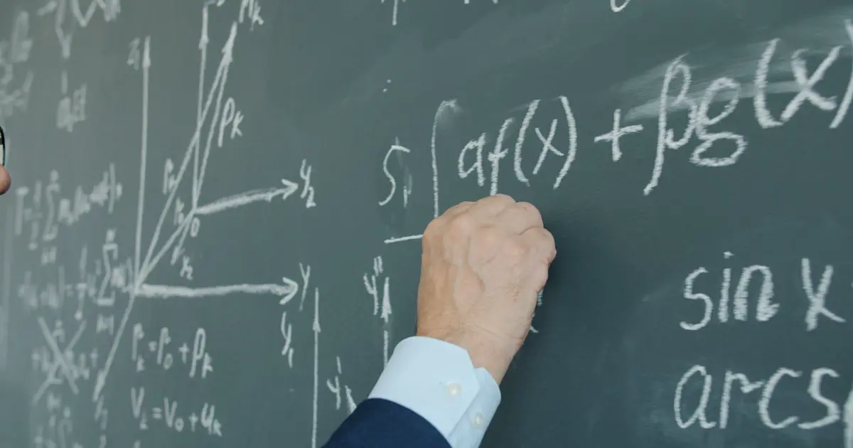 Working through calculus on a chalkboard.