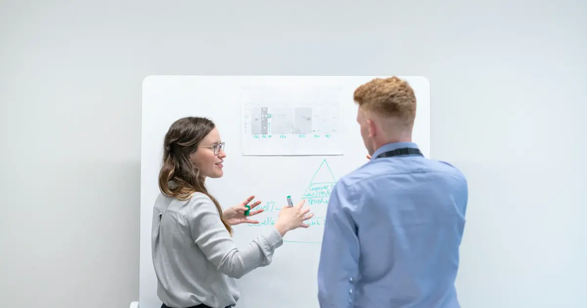 A candidate explaining a solution at a whiteboard.