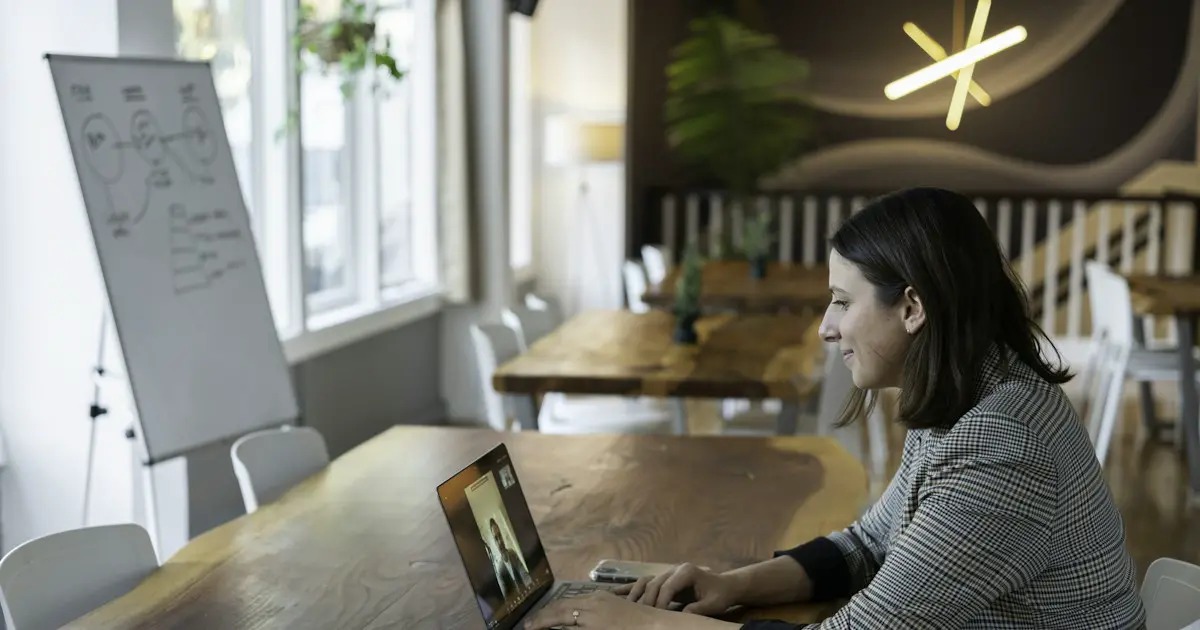 A candidate in a video interview at her laptop.