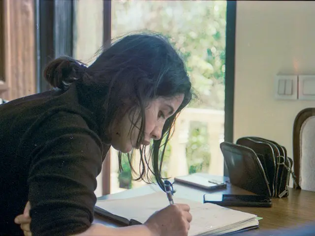 A student going over mistakes in a notebook.