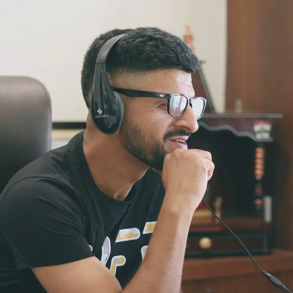A support team member with a headset at a laptop.