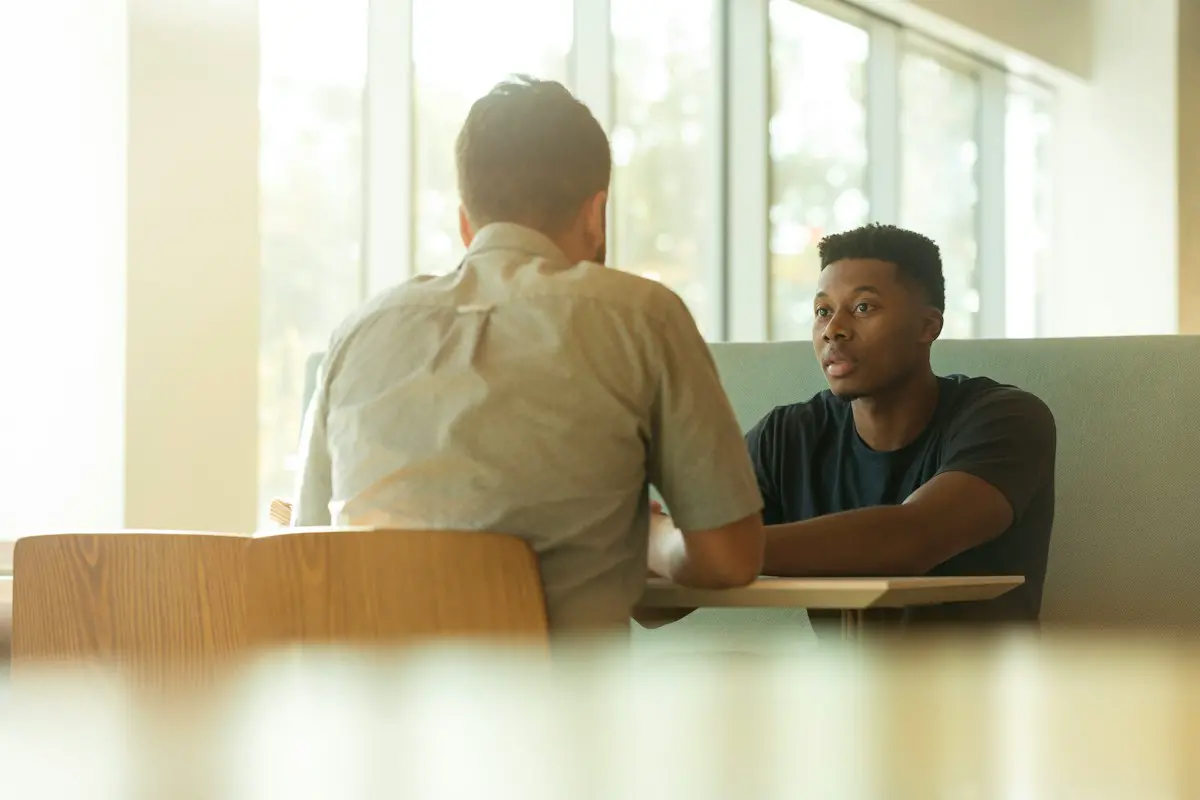 A student asking a senior a question.
